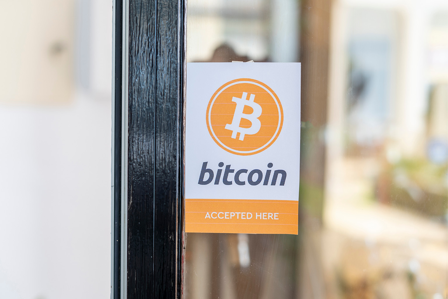 A sign that says that Bitcoin is accepted here